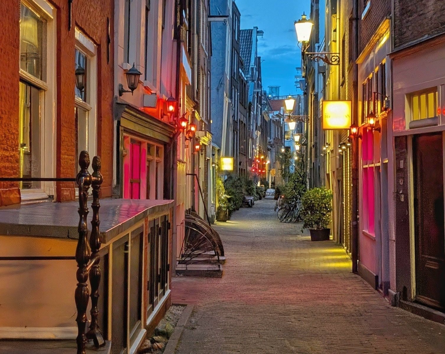 A red-lit alley in De Wallen, Amsterdam, at dusk